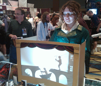 Mary Robinette Kowal does her puppeteer magic in the booth, as James Enge fends off fans