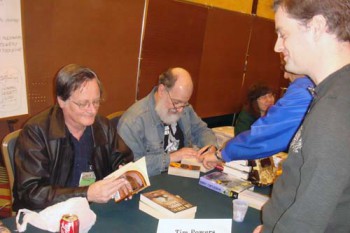 tim-powers-signing Annoying fan bug Tim Powers for his signature. Harry Turtledove sitting to Mr. Powers’s left.