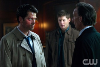 God-Castiel faces off against Death, with Dean Winchester looking on.