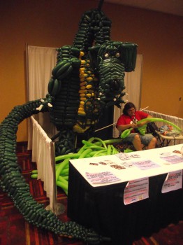 A dragon made of balloons. The light green balloons on the ground are for the wings in progress.