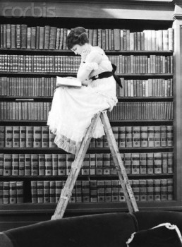 Woman Reading on Top of Ladder