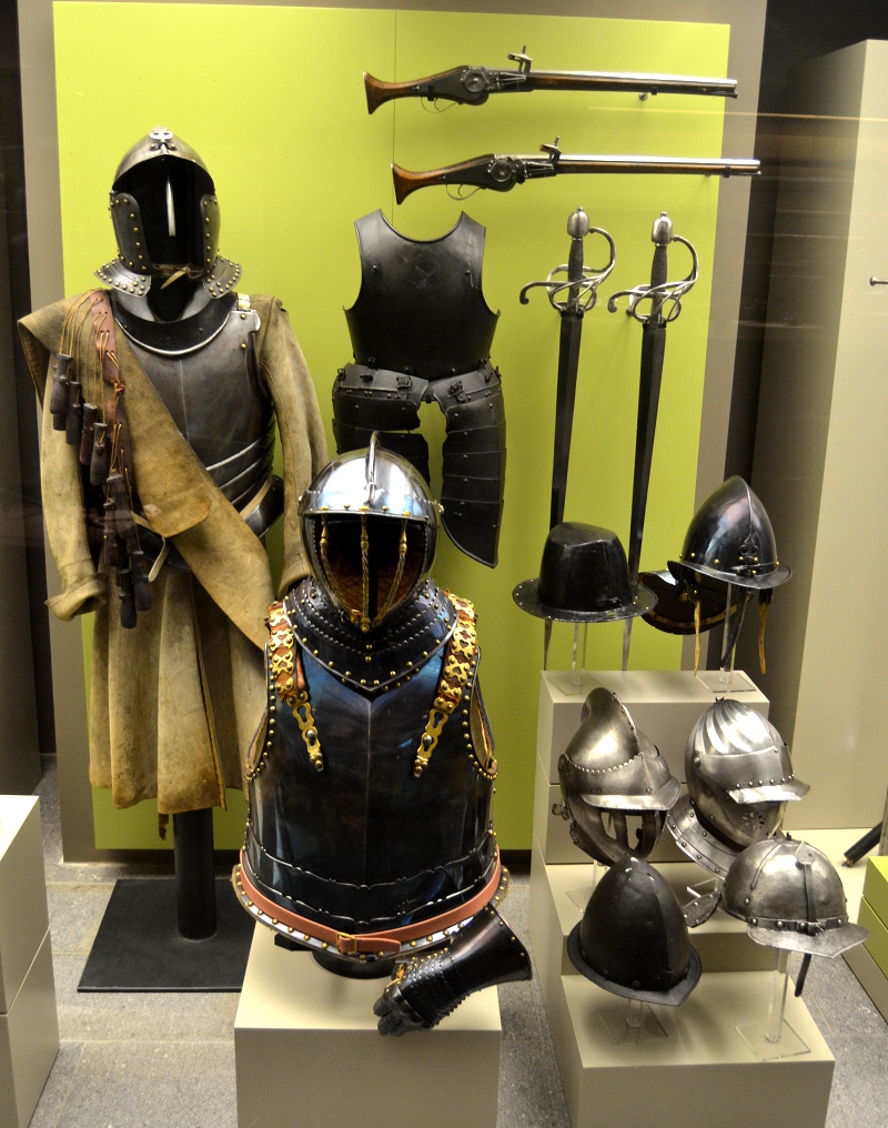 A collection of 17th century arms and armor. The blued steel breastplate in the front dates to the Thirty Years War (1618-1648). Bluing is done by heating the metal to 300°C, polishing it, and reheating it to the same temperature. While it looks nice, it's not very practical because rust can form under the blue exterior layer.
