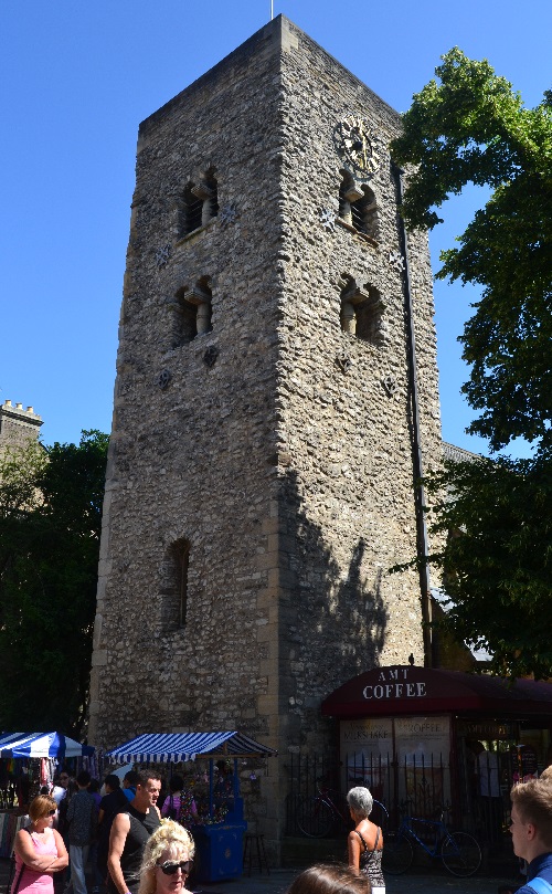 The Saxon Tower rises above a busy shopping street.