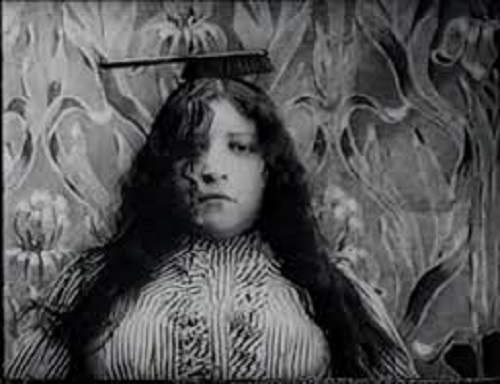 A guest gets her hair done by a self-moving brush in The Electric Hotel, 1908.
