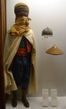 Above is a uniform of a French Spahi, a colonial soldier from northwest Africa from 1914. To the right is a French issue Adrian helmet and a hat distributed to troops from Indochina. Image copyright Sean McLachlan.