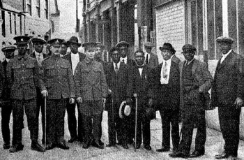 Black recruits from Cardiff, Wales, pose with recruiting officers for the British army.