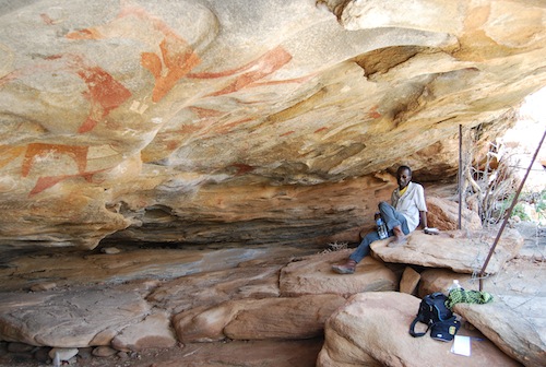 Ali from the Somaliland Department of Antiquities, poses in one of the painted rock shelters of Laas Geel.