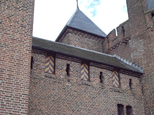 A closer look at the battlements. The rounded portions of the arrow slits are for guns.