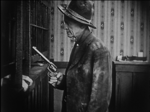 Who needs good posture when you have a gun in your hand? Al Jennings makes a withdrawal.