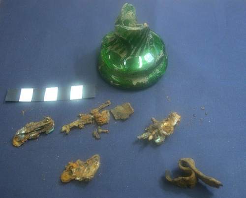 A fragmentary witch bottle with corroded metal remains that appear to be bent pins. Photo courtesy Portable Antiquities Scheme.