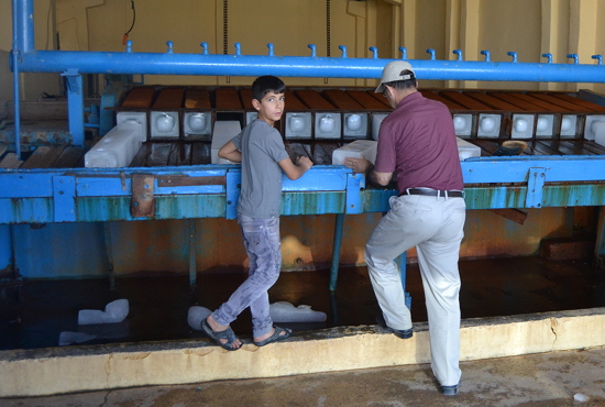 This boy helped run his dad's ice factory in a Christian community near Mosul.
