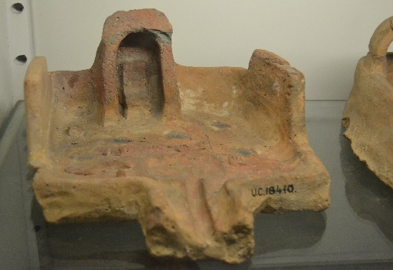 Clay offering table. Note that offerings are painted onto the surface.