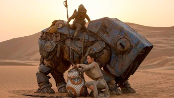 Still from new movie showing Rey freeing droid BB-8 from a net. Teedo is the name of the character riding a "luggabeast" in the dunes of Jakku. Now you know, and knowing is half the battle.