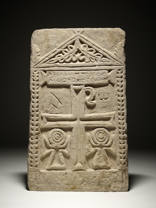 Gravestone of ‘Abraham, the perfected monk’, Egypt, 7th century AD. Many early Coptic Christian carvings show the anceitn Egyptian sign for "life", the ankha, next to Christian symbols such as the cross and the Chi-Rho. © The Trustees of the British Museum