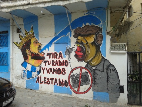 "Throw away your radio and let's go to the stadium!" The local football team, Ultra Hercules, has been in second division for years but just made it to first division. Now the fans are getting revved up.