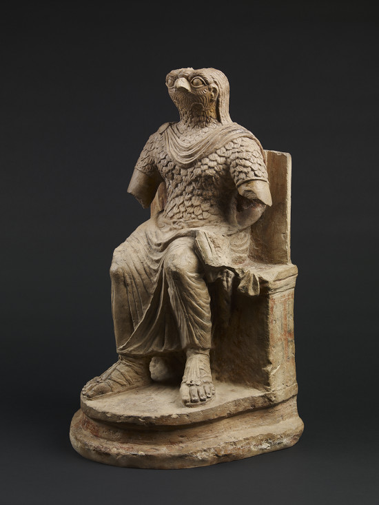 Seated figure of the ancient Egyptian god Horus, wearing Roman military costume, limestone, Egypt, 1st–2nd century AD © The Trustees of the British Museum